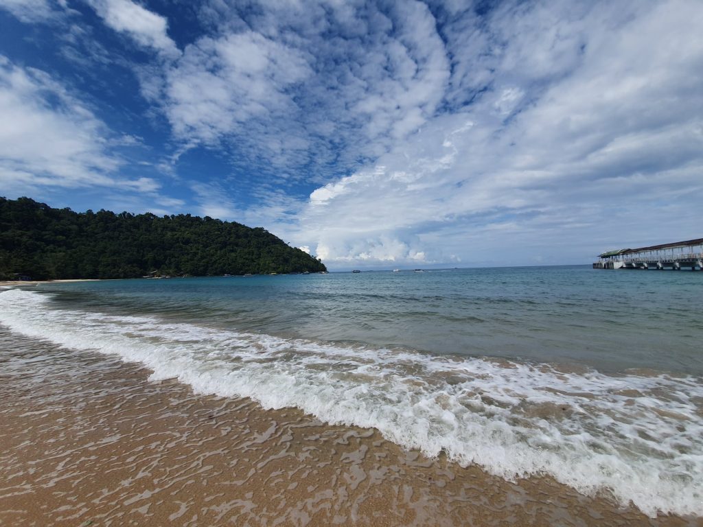 White sand and blue skies of Juara beach in Tioman Island.