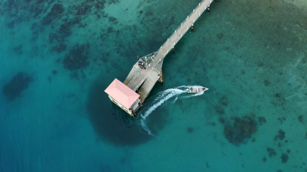 Azure blue seas around a dock in Tioman Island.