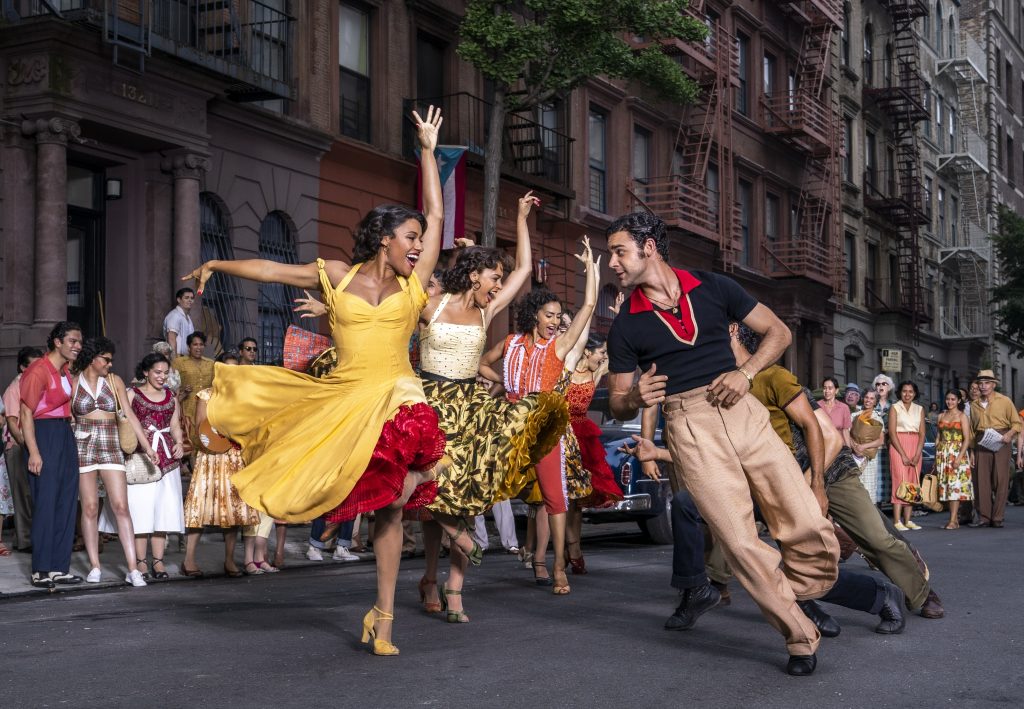 Ariana DeBrose, who became the first queer woman of colour to win an Oscar, dancing in a yellow dress on the set of West Side Story.