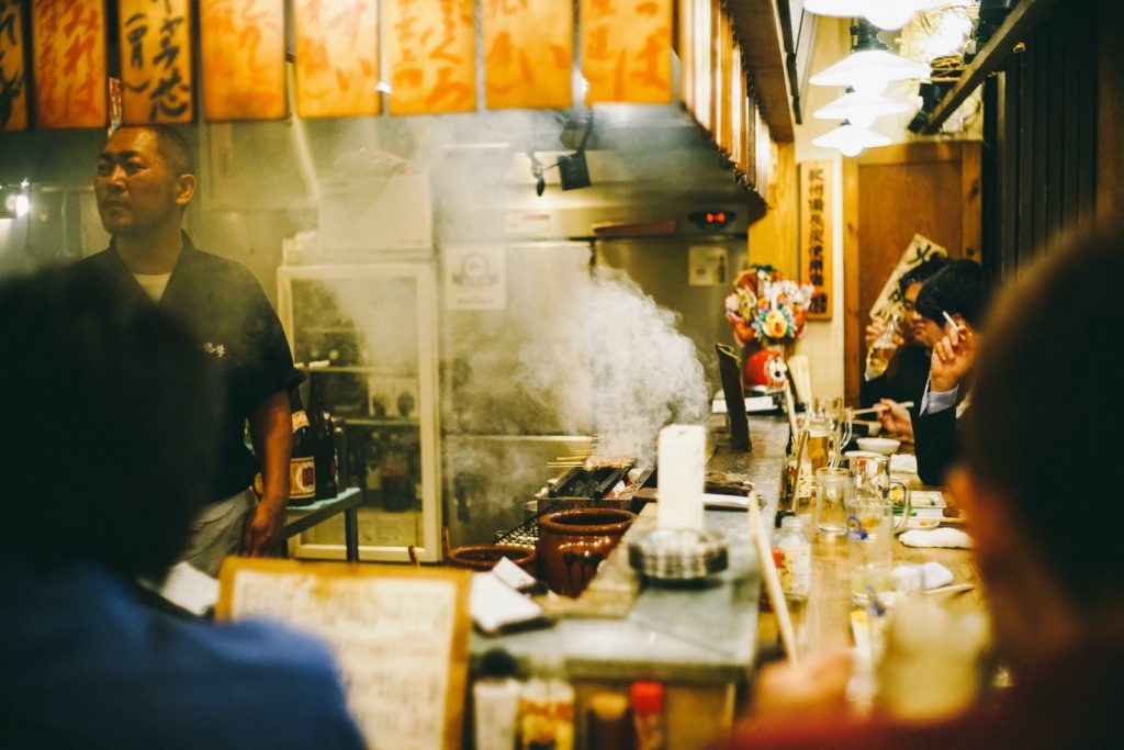 A small restaurant in Japan where people eat and drink.
