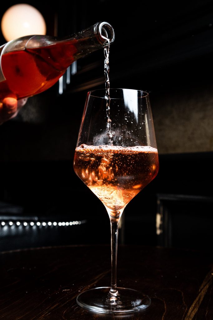 Wine being poured into a glass.