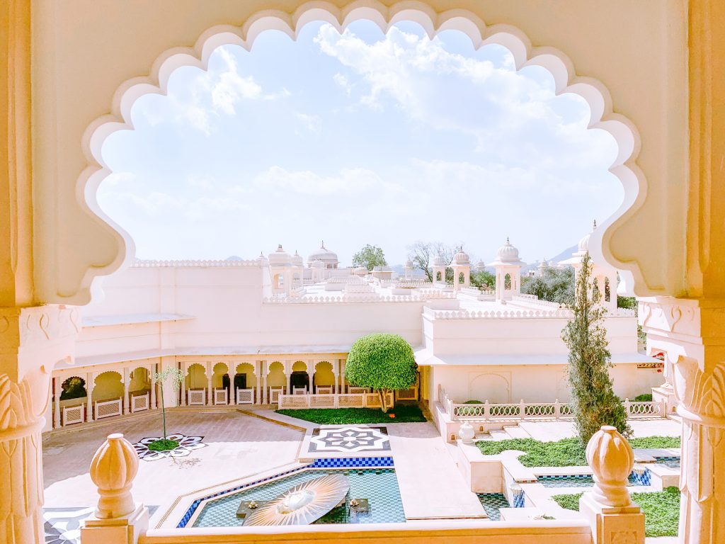 View through a keyhole arch of the garden in a hotel in Udaipur.