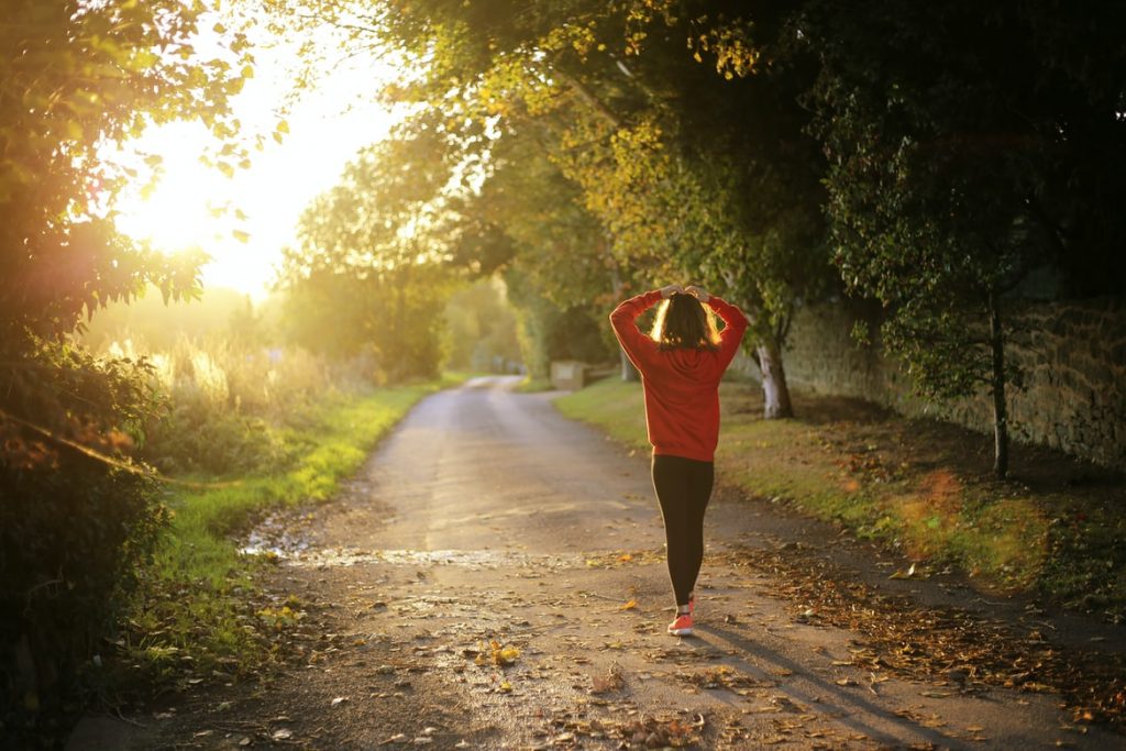 A women walks on a scenic path in the morning. Stanly Ranch offers miles of walking paths.