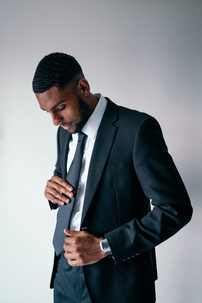 A man wearing a well fitting suit, clothes that fit well and last longer are better for the environment and your confidence. 