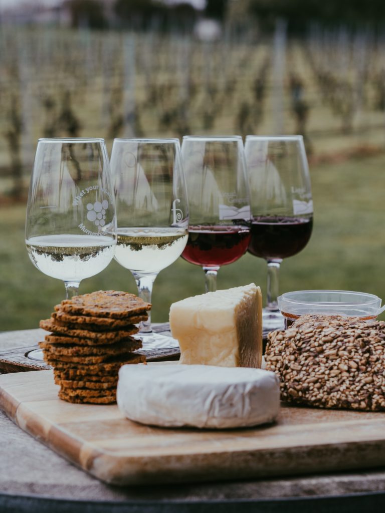 Glasses of wine with soft cheese and bread.