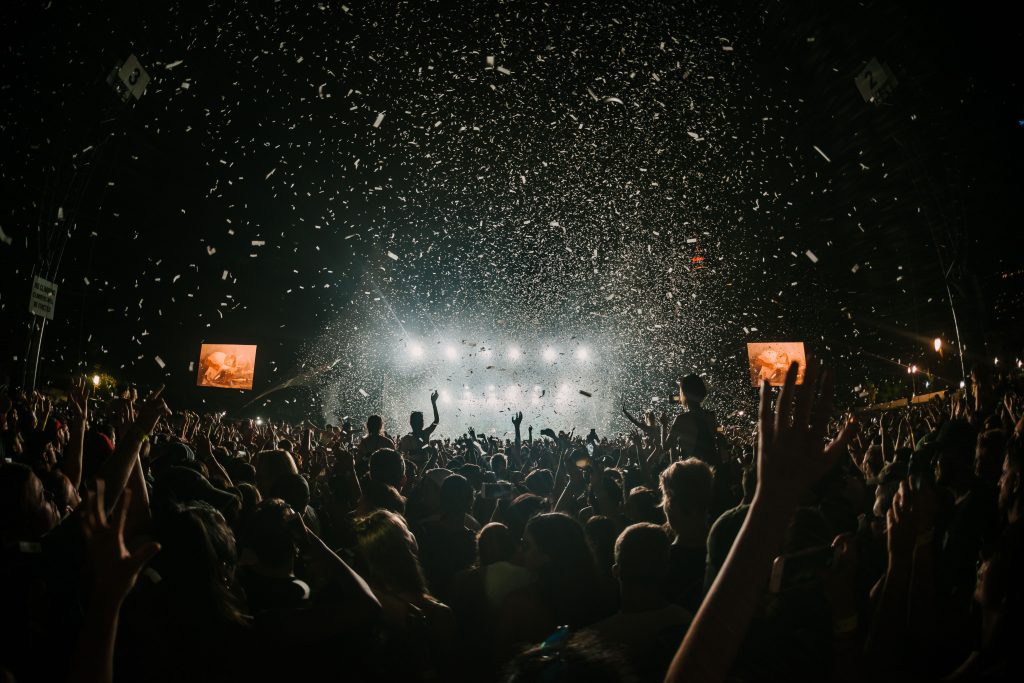 People in front of the stage at a music festival or concert.