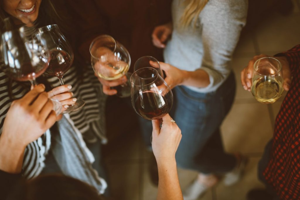 Women holding glasses of wine.